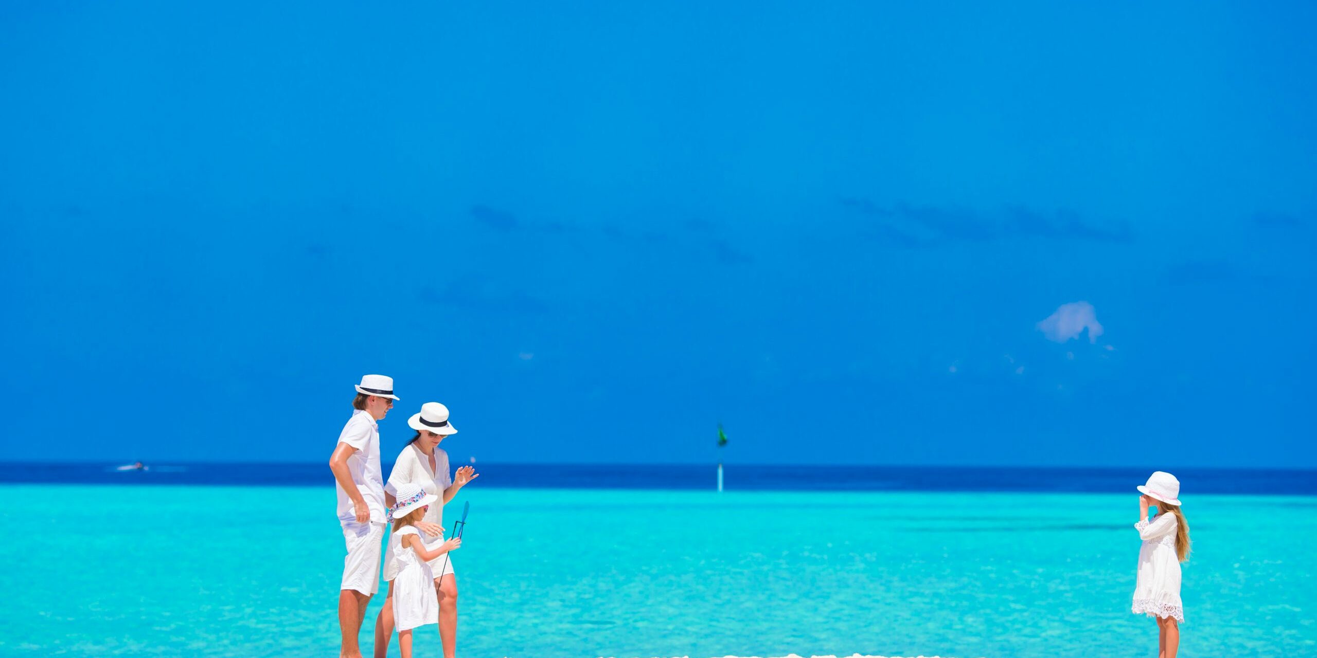 Happy beautiful family on a beach during summer vacation